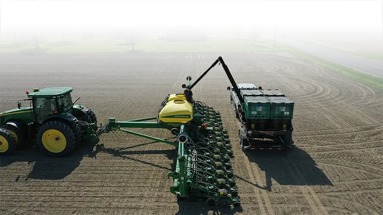 Filling a planter with a Pro Box Seed Tender