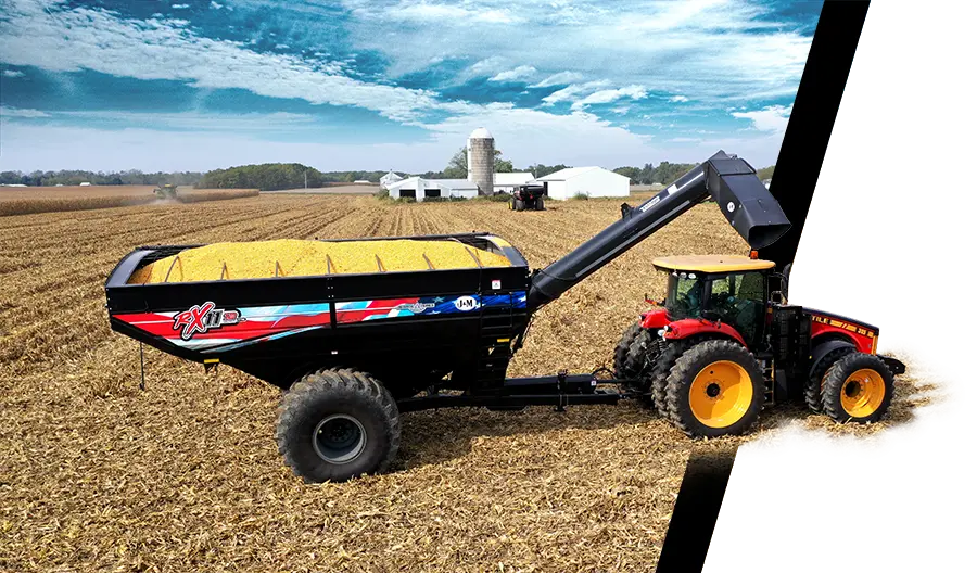a black 1112 grain cart with a patriotic farmer decal sitting in a corn field