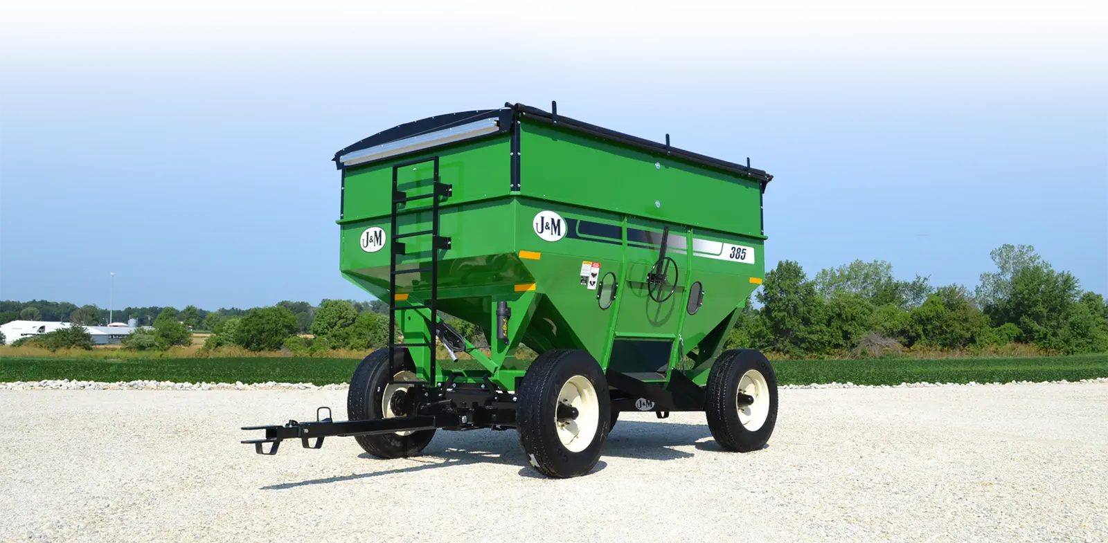 a 385 gravity wagon next to a field 