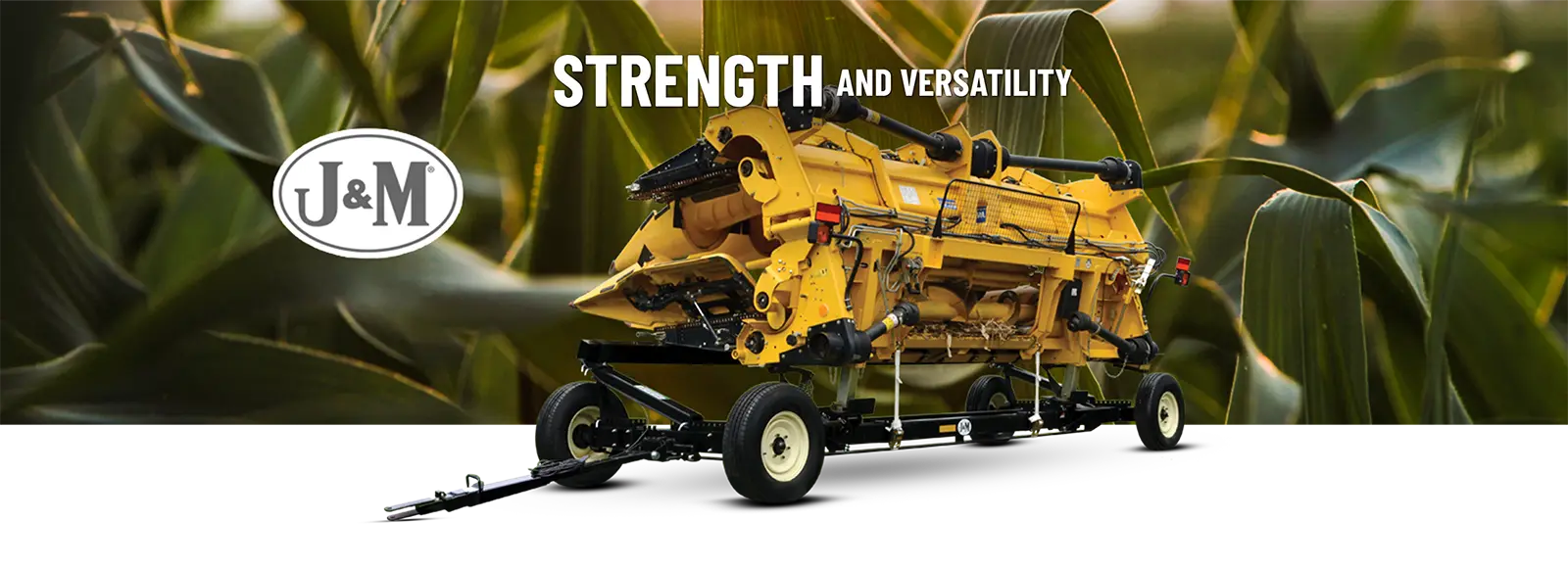 a low profile header transport HD with a yellow folded corn head on it, in front a field with a blue sky background.