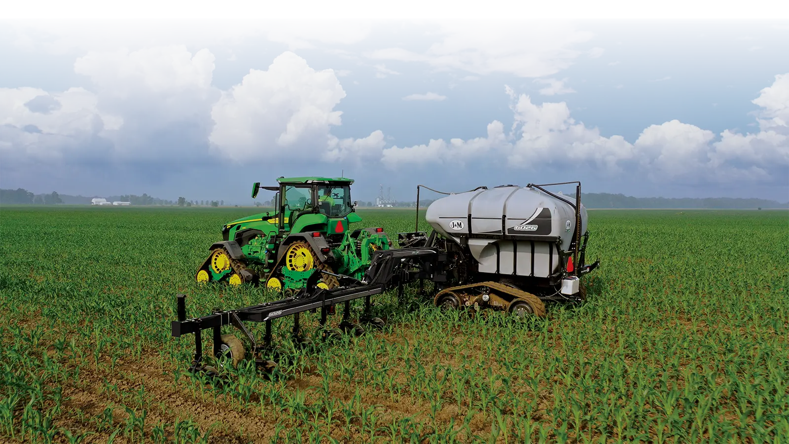a black 6026 nitrogen applicator being pulled in a field