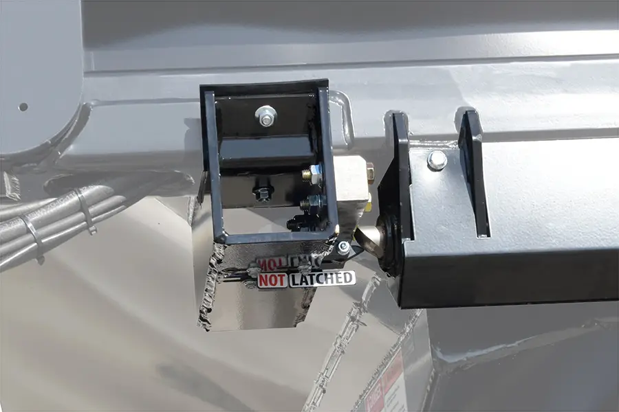 Close up view of the automated conveyor latching system on the LX seed tender with the conveyor unlatched