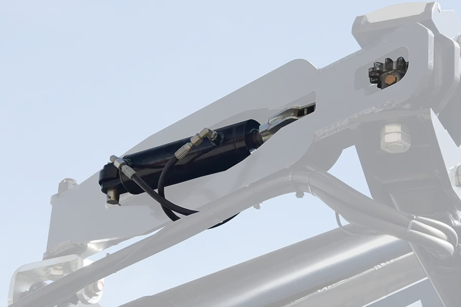 a close up of the cylinder in the arm linkage of the seed tenders second arm.